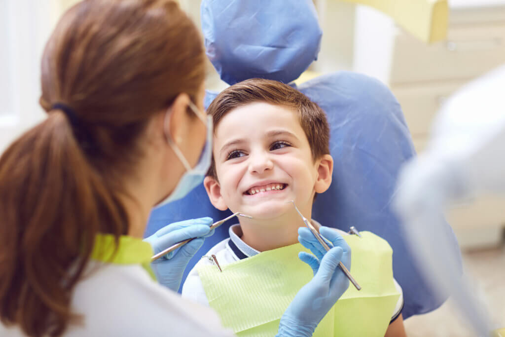 Kid smiling at the dentist