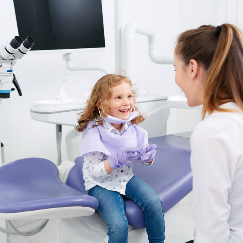 child sits on dentist chair
